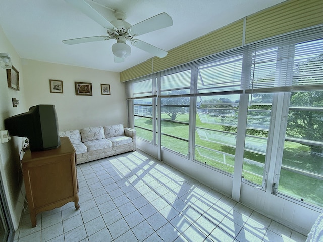 sunroom / solarium featuring ceiling fan