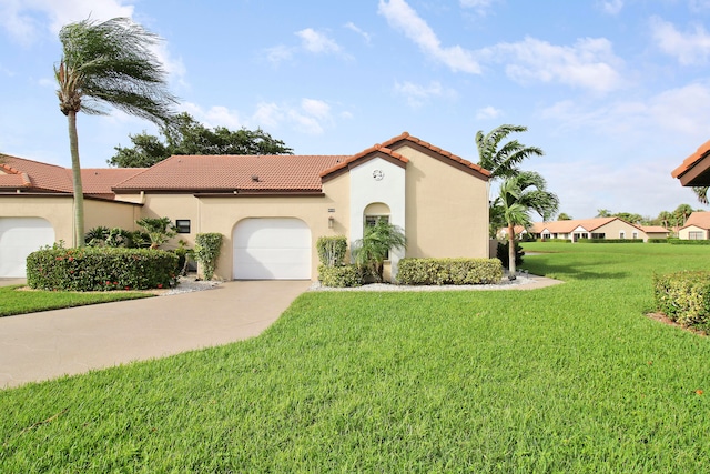 mediterranean / spanish house with a garage and a front lawn