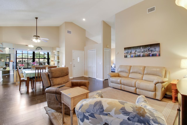 living room featuring ceiling fan, wood-type flooring, and high vaulted ceiling