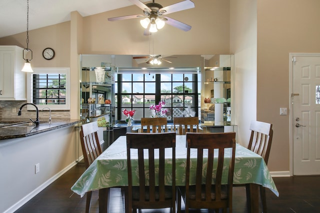 dining area featuring high vaulted ceiling, sink, ceiling fan, and dark hardwood / wood-style floors