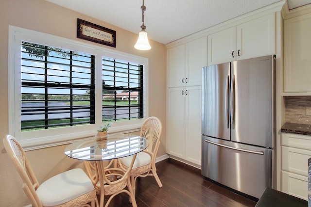 dining space with dark hardwood / wood-style flooring