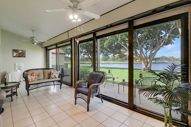 sunroom with a wealth of natural light, a water view, lofted ceiling, and ceiling fan