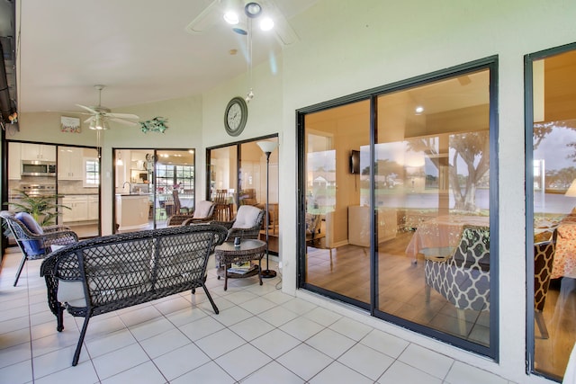 sunroom / solarium featuring sink, vaulted ceiling, and ceiling fan