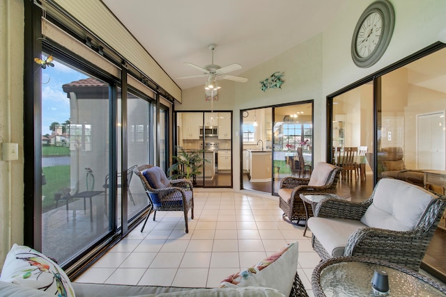 sunroom / solarium featuring lofted ceiling, sink, and ceiling fan