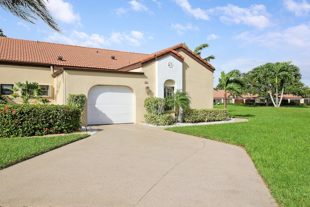 mediterranean / spanish home with a front yard and a garage