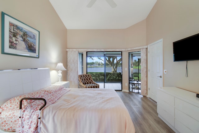 bedroom with ceiling fan, access to exterior, light wood-type flooring, and lofted ceiling