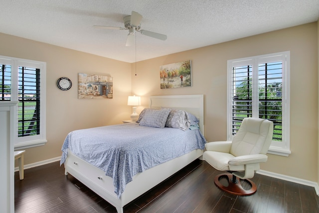 bedroom with dark hardwood / wood-style flooring, a textured ceiling, and ceiling fan