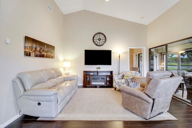 living room with wood-type flooring and high vaulted ceiling