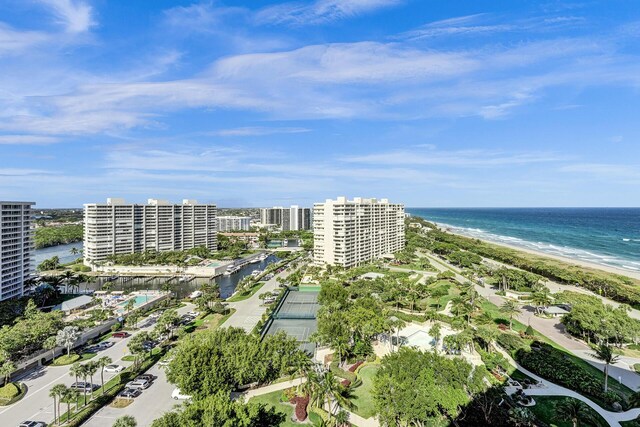 birds eye view of property featuring a water view and a beach view