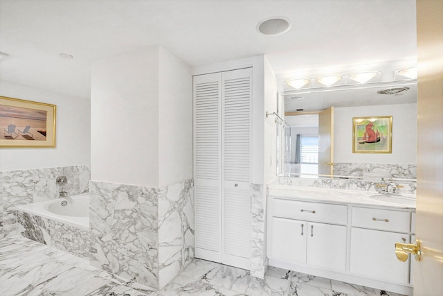 bathroom with a relaxing tiled tub and vanity