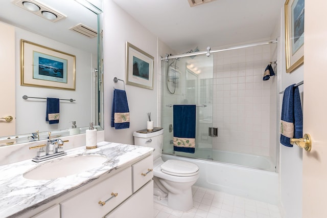 full bathroom with enclosed tub / shower combo, vanity, and toilet