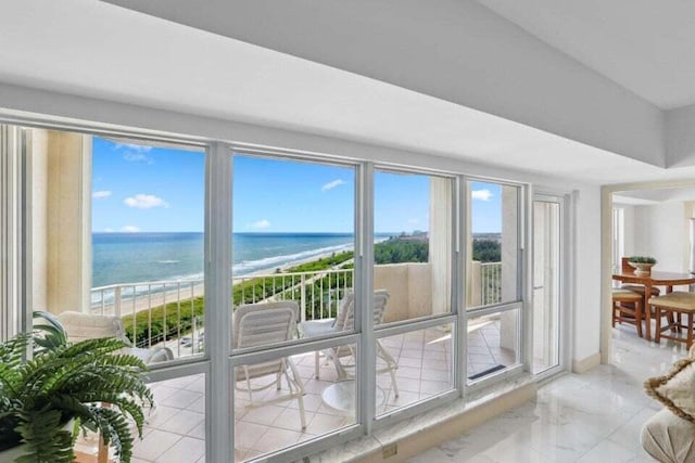 doorway with a water view and a beach view