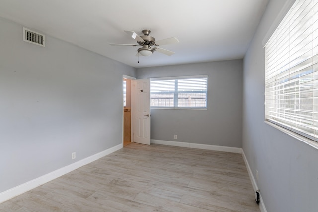 spare room with light hardwood / wood-style floors and ceiling fan