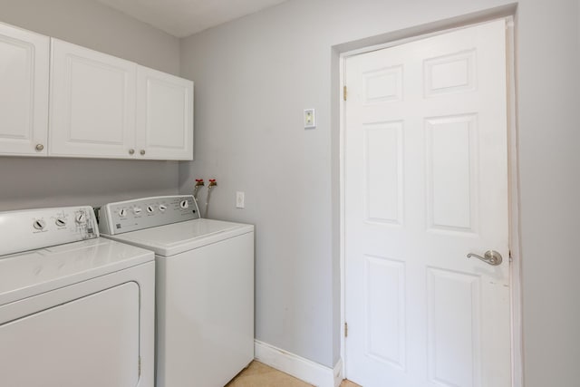 laundry area with cabinets and washing machine and clothes dryer