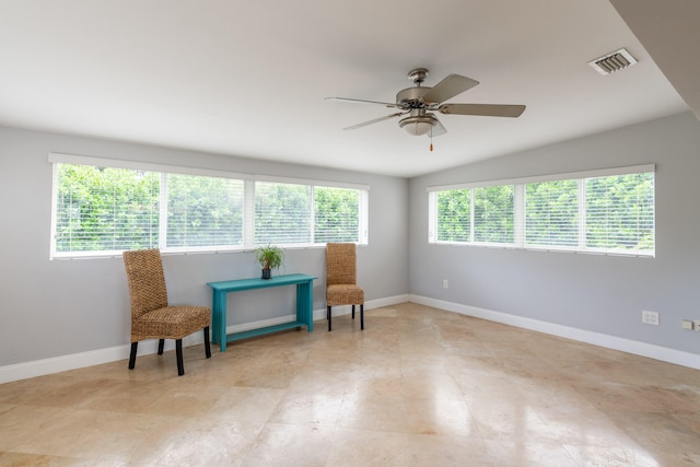 living area featuring ceiling fan and plenty of natural light