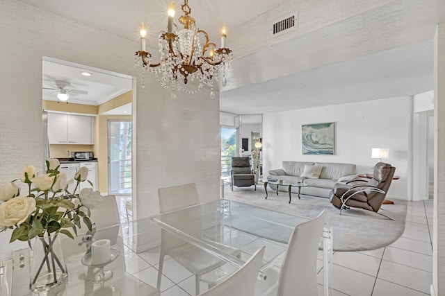 dining room featuring plenty of natural light, light tile patterned floors, a textured ceiling, and ceiling fan with notable chandelier