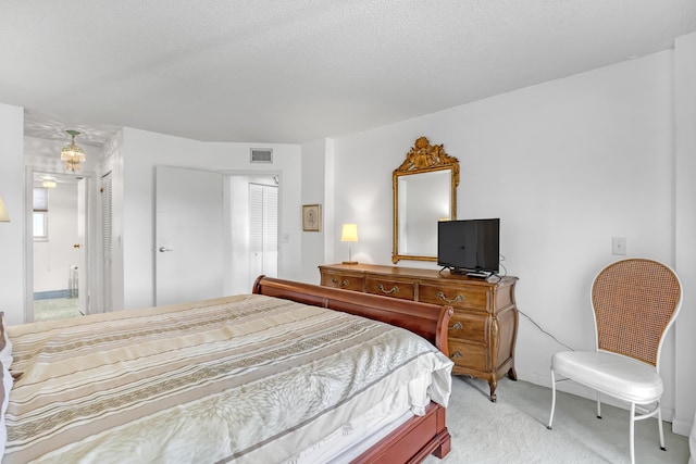 carpeted bedroom with multiple windows and a textured ceiling