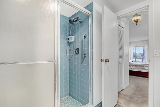 bathroom featuring a shower with shower door