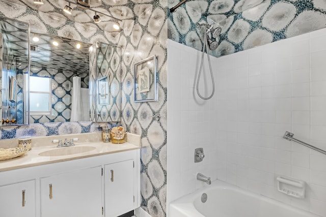 bathroom with vanity and tiled shower / bath