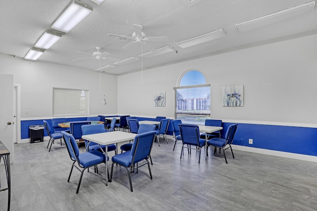 dining area with a textured ceiling and ceiling fan