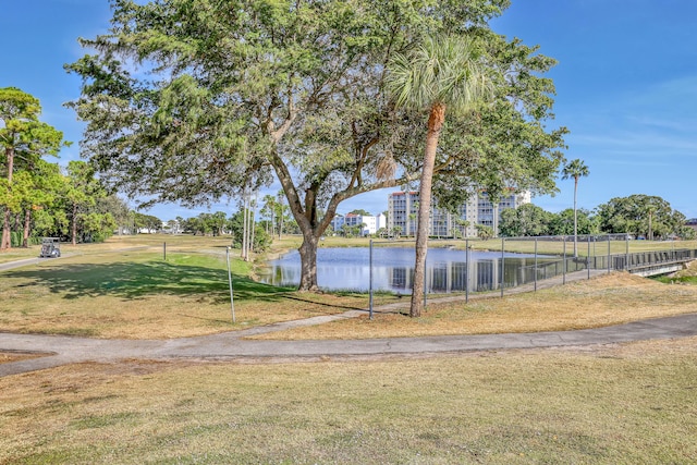 surrounding community featuring a lawn and a water view