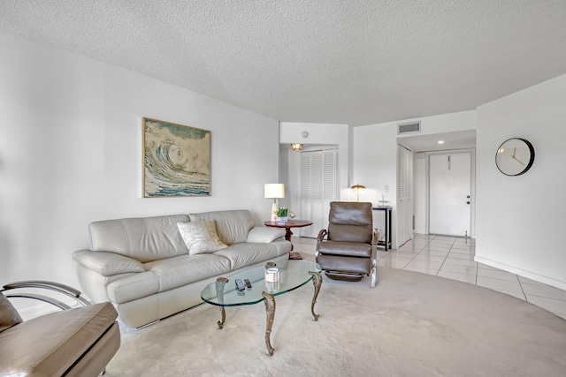 living room featuring light carpet and a textured ceiling