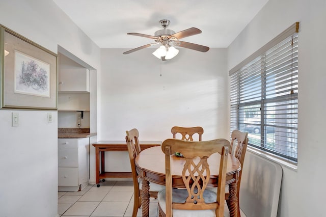 dining room with ceiling fan and light tile patterned flooring