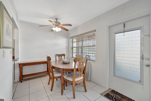 tiled dining space with ceiling fan