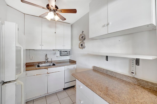 kitchen with tasteful backsplash, white cabinetry, light tile patterned flooring, sink, and white appliances