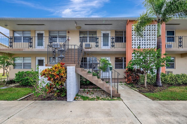 view of exterior entry with a wall unit AC