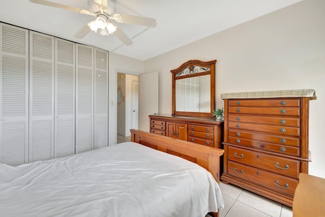 tiled bedroom featuring a closet and ceiling fan