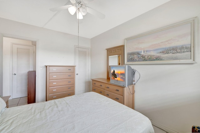 tiled bedroom with ceiling fan