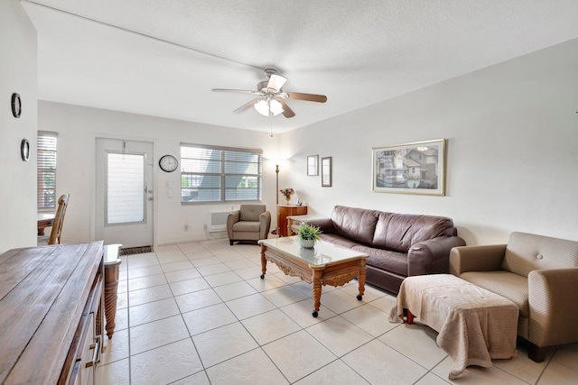 tiled living room featuring a textured ceiling and ceiling fan