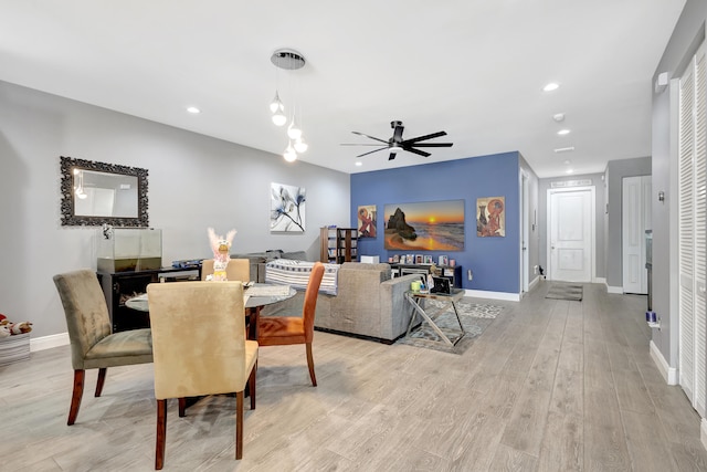 dining room with light wood-type flooring and ceiling fan