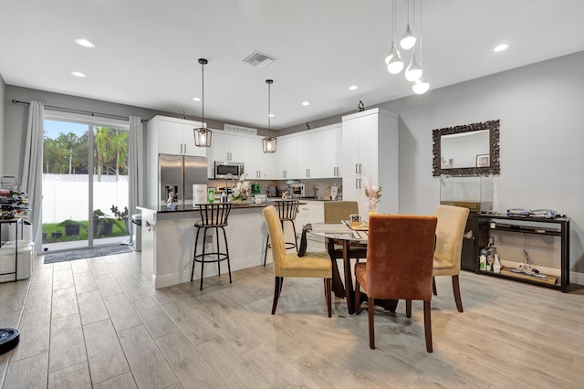 dining space with light wood-type flooring