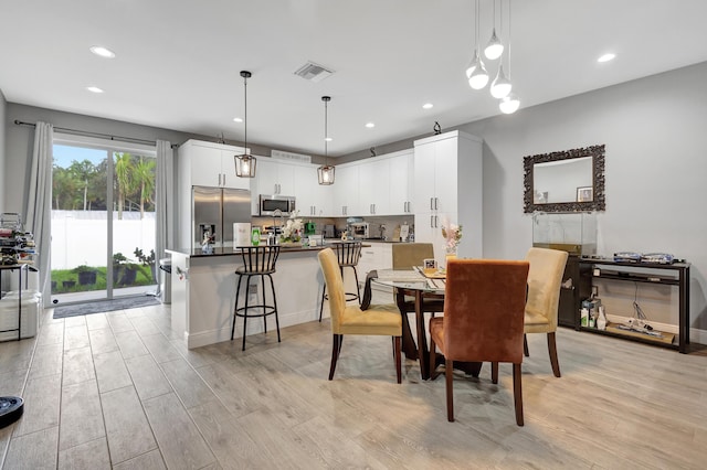 166 Neva Dr, West Palm Beach, FL 33415 - dining area with light wood-style flooring, recessed lighting, and baseboards