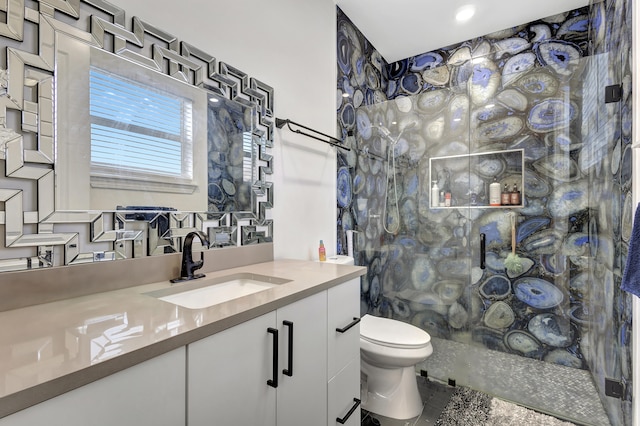 bathroom with toilet, walk in shower, vanity, and tasteful backsplash