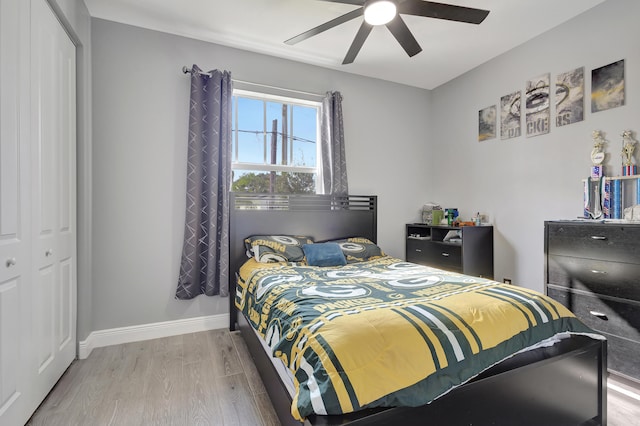 bedroom featuring light hardwood / wood-style flooring, a closet, and ceiling fan