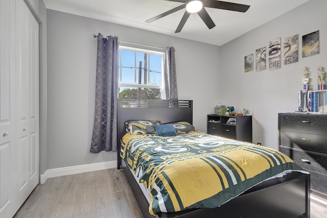 166 Neva Dr, West Palm Beach, FL 33415 - bedroom featuring wood finished floors, a closet, baseboards, and ceiling fan