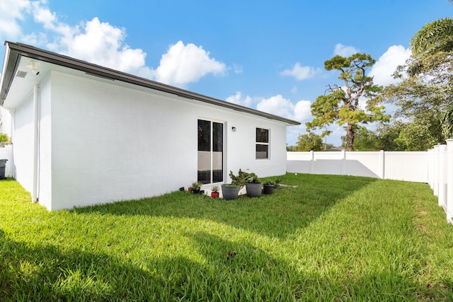 rear view of property with a lawn