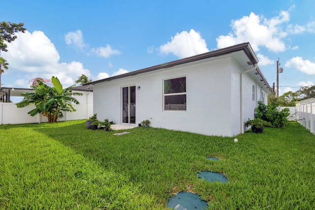 166 Neva Dr, West Palm Beach, FL 33415 - back of house featuring stucco siding