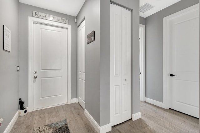 hall with light hardwood / wood-style floors