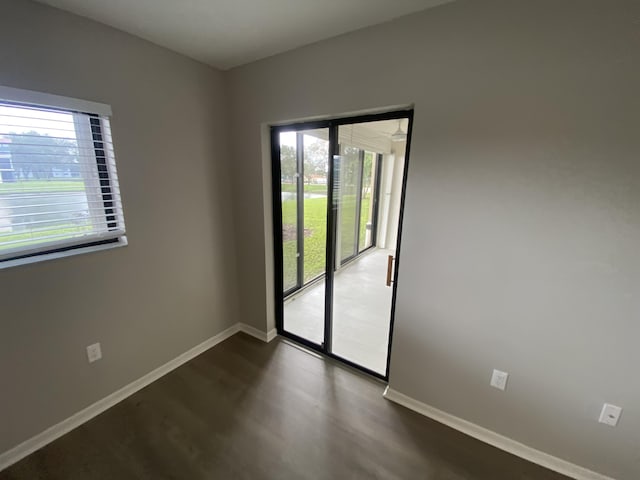 15324 Lakes Of Delray Blvd Unit 104, Delray Beach, FL 33484 - empty room featuring baseboards and dark wood-type flooring