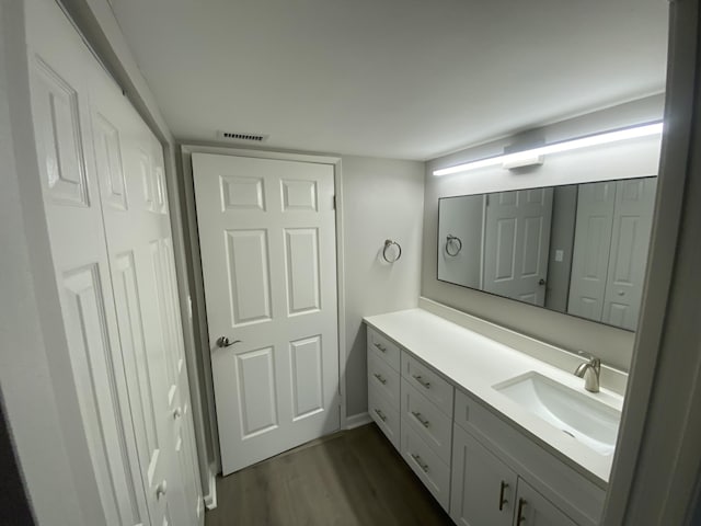 15324 Lakes Of Delray Blvd Unit 104, Delray Beach, FL 33484 - bathroom featuring vanity and wood finished floors
