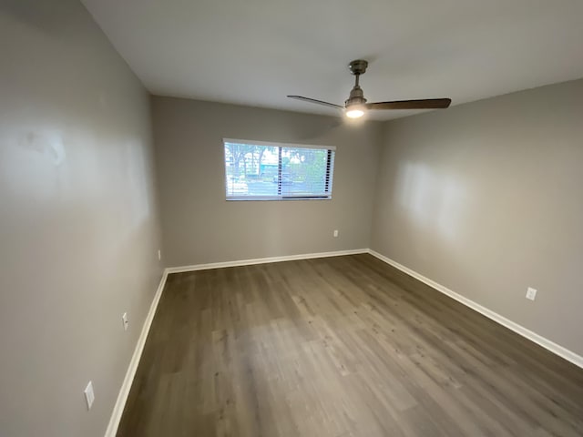 15324 Lakes Of Delray Blvd Unit 104, Delray Beach, FL 33484 - unfurnished room featuring baseboards, a ceiling fan, and dark wood finished floors
