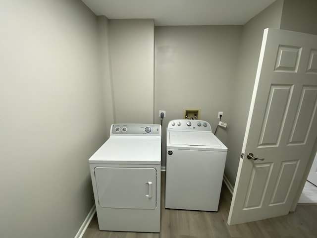 15324 Lakes Of Delray Blvd Unit 104, Delray Beach, FL 33484 - laundry room featuring washing machine and dryer, light wood-style flooring, and baseboards