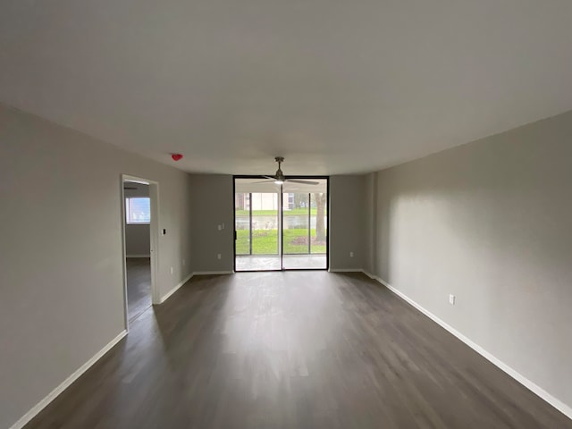 spare room featuring dark wood-type flooring and ceiling fan