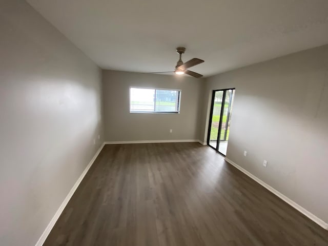 unfurnished room featuring ceiling fan and dark hardwood / wood-style flooring