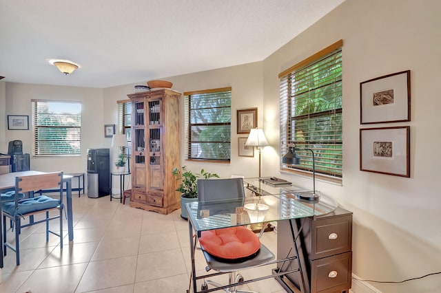 home office with a textured ceiling and light tile patterned floors