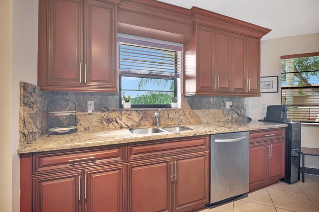 kitchen featuring dishwasher, sink, light tile patterned flooring, light stone counters, and tasteful backsplash